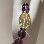 Gentle amethyst crystals frame a single citrine star; sterling glimmers mimic milky way dust—beauty so deep you’ll never take the bracelet off.