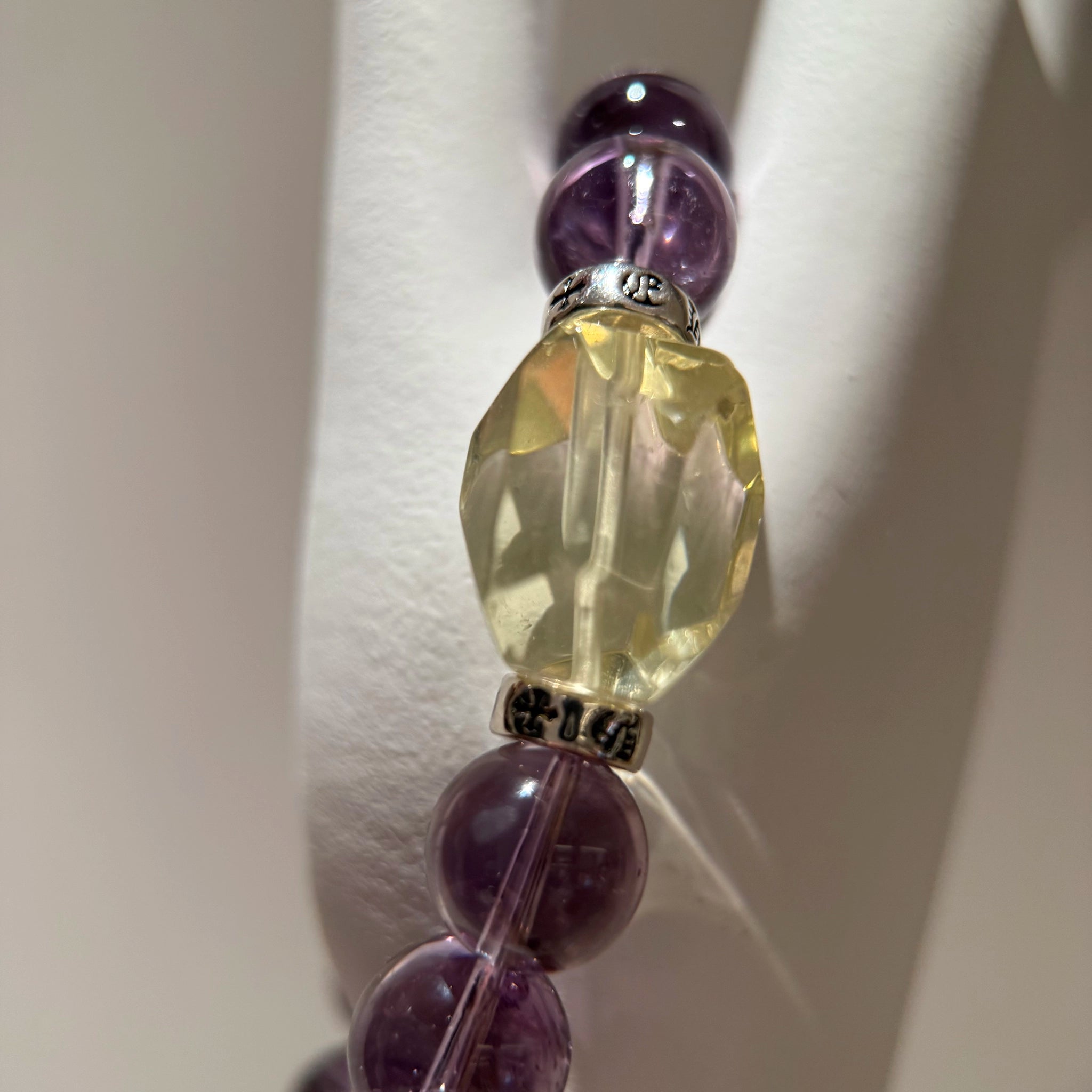 Gentle amethyst crystals frame a single citrine star; sterling glimmers mimic milky way dust—beauty so deep you’ll never take the bracelet off.