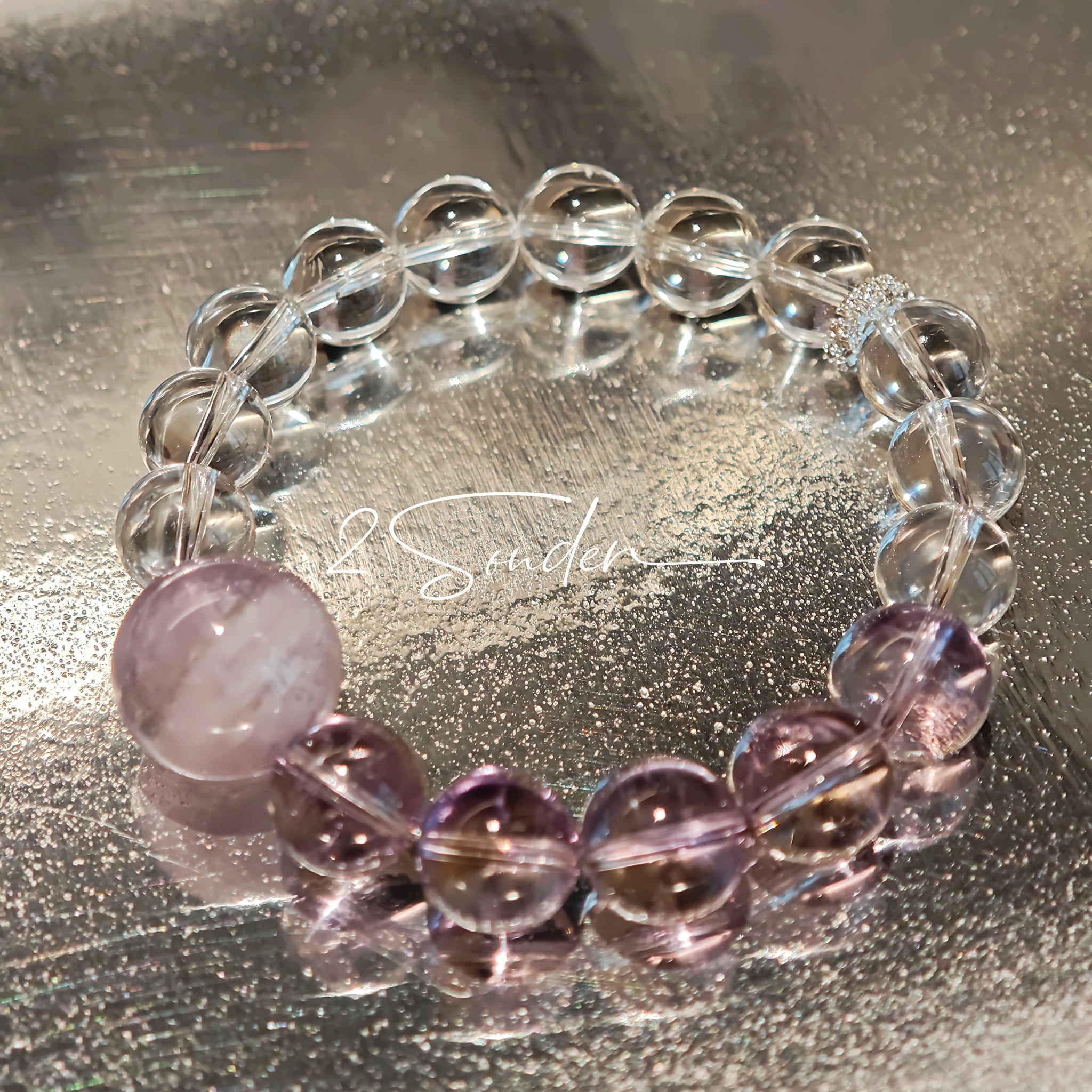 This handcrafted bracelet blends the serene clarity of clear quartz with the dreamy, calming energy of amethyst. The gradient of purple and clear beads creates a timeless, elegant look, perfect for bringing balance, intuition, and positive energy to your everyday style. A stunning piece for crystal lovers and minimalist jewelry enthusiasts alike.