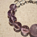 This handcrafted bracelet blends the serene clarity of clear quartz with the dreamy, calming energy of amethyst. The gradient of purple and clear beads creates a timeless, elegant look, perfect for bringing balance, intuition, and positive energy to your everyday style. A stunning piece for crystal lovers and minimalist jewelry enthusiasts alike.