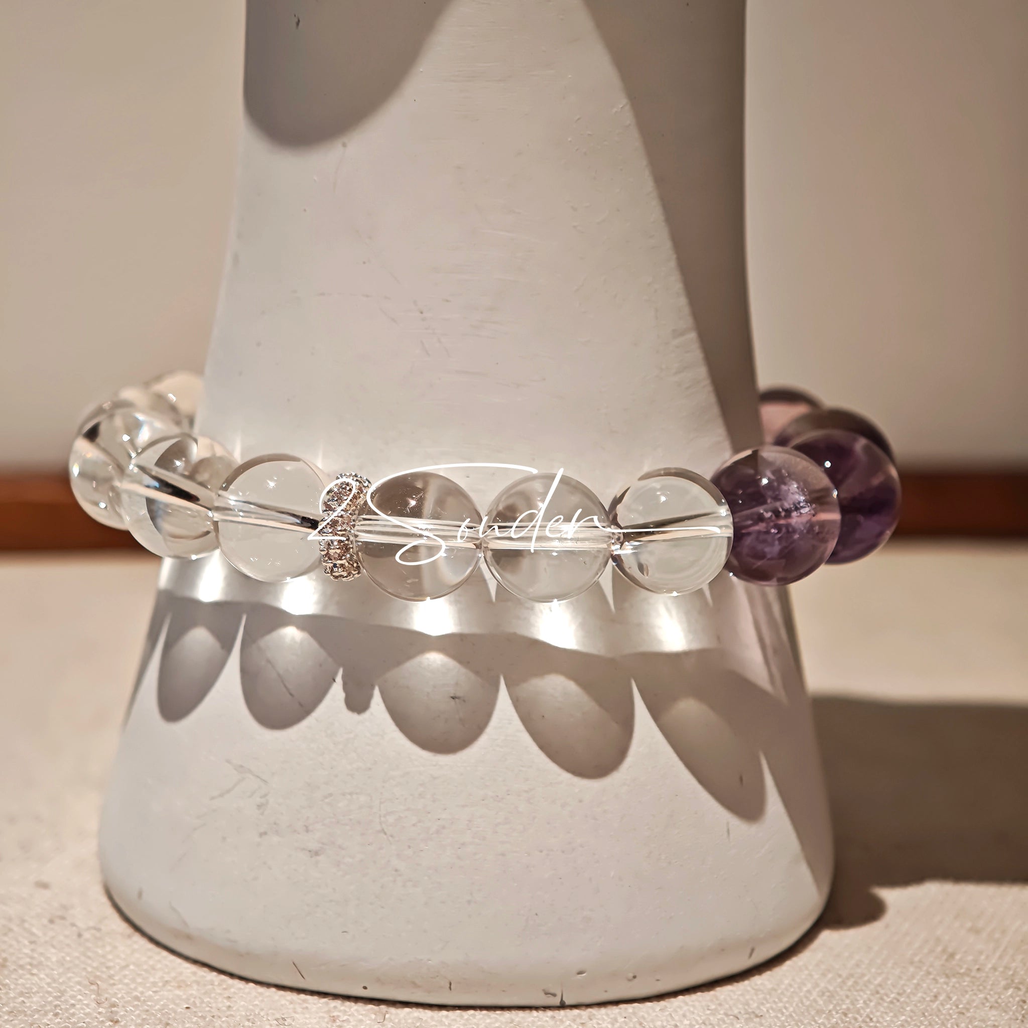 This handcrafted bracelet blends the serene clarity of clear quartz with the dreamy, calming energy of amethyst. The gradient of purple and clear beads creates a timeless, elegant look, perfect for bringing balance, intuition, and positive energy to your everyday style. A stunning piece for crystal lovers and minimalist jewelry enthusiasts alike.