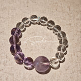 This handcrafted bracelet blends the serene clarity of clear quartz with the dreamy, calming energy of amethyst. The gradient of purple and clear beads creates a timeless, elegant look, perfect for bringing balance, intuition, and positive energy to your everyday style. A stunning piece for crystal lovers and minimalist jewelry enthusiasts alike.