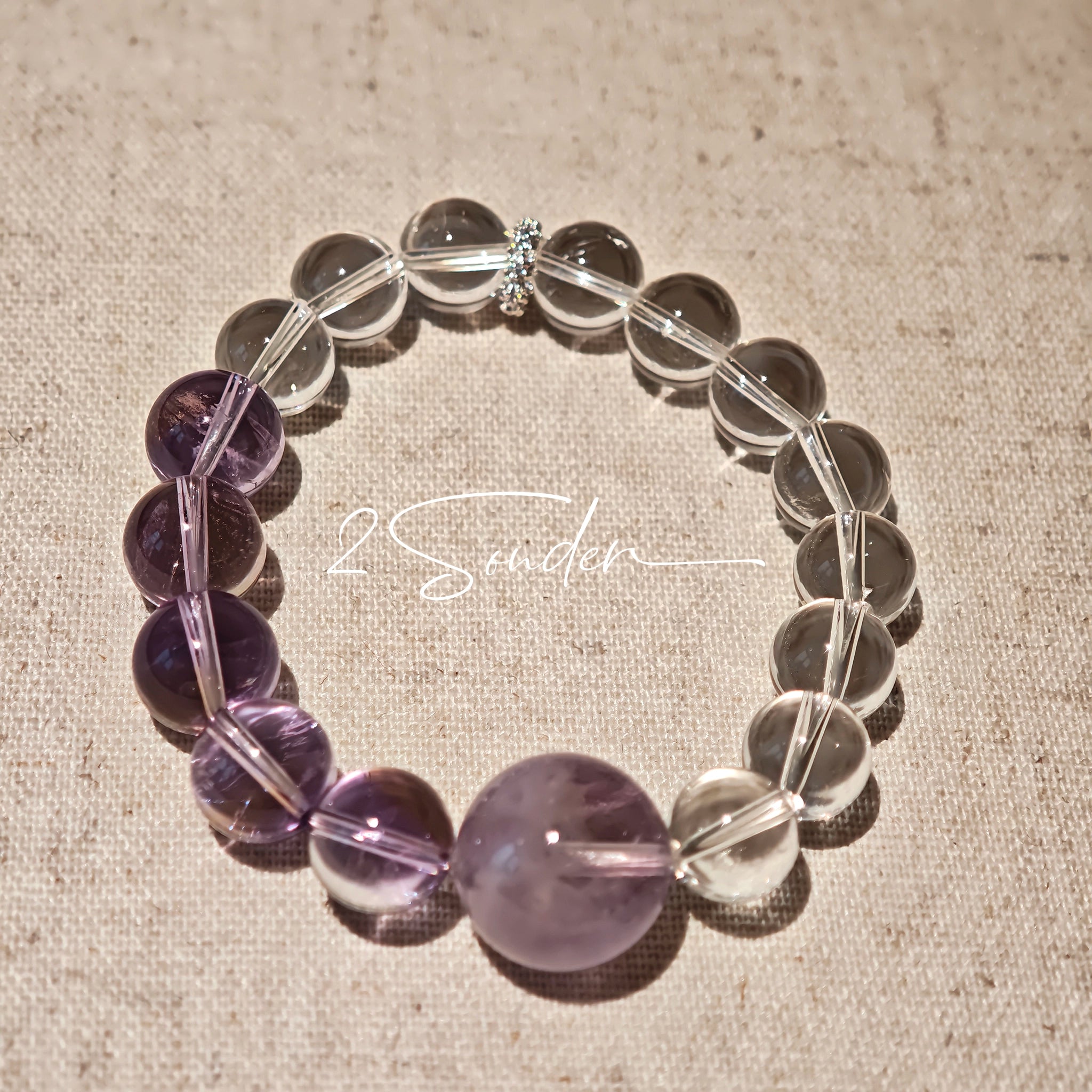 This handcrafted bracelet blends the serene clarity of clear quartz with the dreamy, calming energy of amethyst. The gradient of purple and clear beads creates a timeless, elegant look, perfect for bringing balance, intuition, and positive energy to your everyday style. A stunning piece for crystal lovers and minimalist jewelry enthusiasts alike.