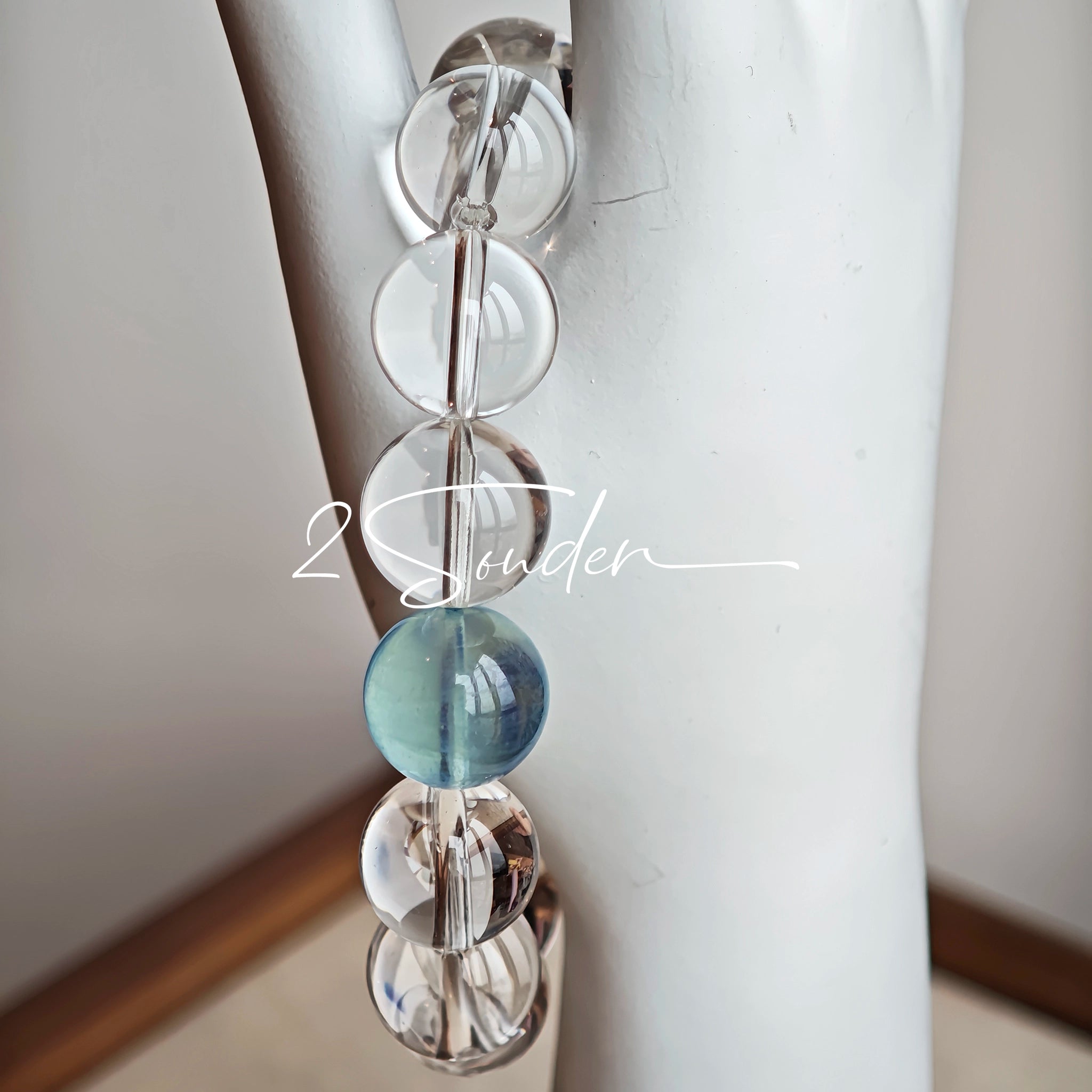 This is a crystal bracelet consists of 1 aquamarine and 13pcs of pure clear quartz.