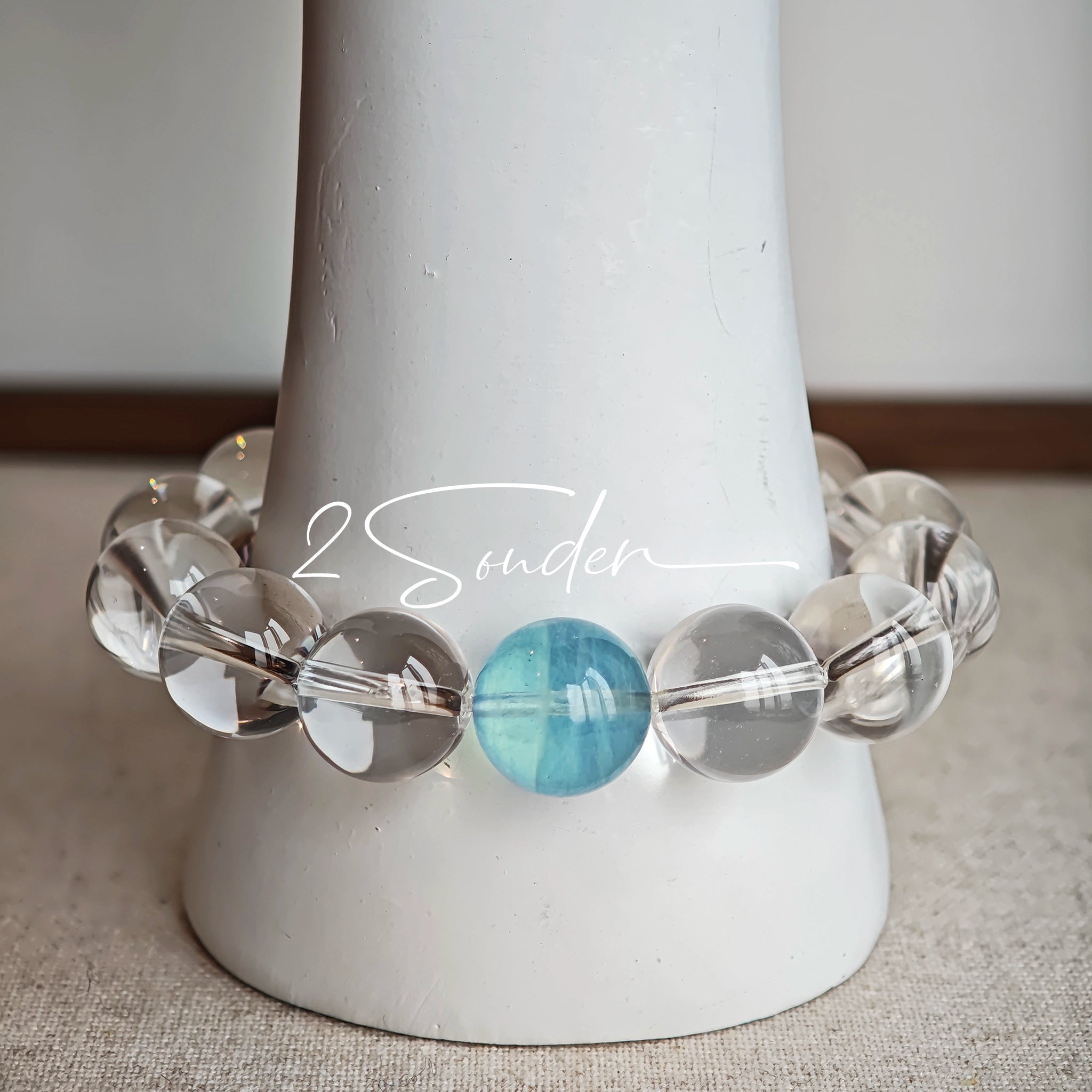 This is a crystal bracelet consists of 1 aquamarine and 13pcs of pure clear quartz.