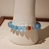 This is a gemstone bracelet that consists of 19pcs of 7-8mm aquamarine beads and 1pcs of red rutilated quartz. There are also 2 silver spacer beads in the bracelet. The main color of the bracelet is sky blue. The entire bracelet is translucent and beautiful.