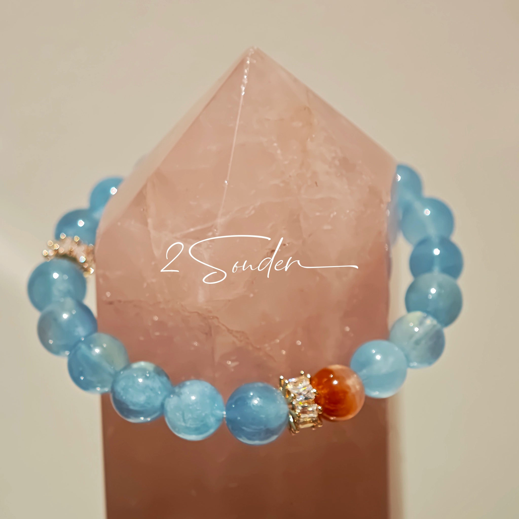 This is a gemstone bracelet that consists of 19pcs of 7-8mm aquamarine beads and 1pcs of red rutilated quartz. There are also 2 silver spacer beads in the bracelet. The main color of the bracelet is sky blue. The entire bracelet is translucent and beautiful.
