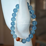 This is a gemstone bracelet that consists of 19pcs of 7-8mm aquamarine beads and 1pcs of red rutilated quartz. There are also 2 silver spacer beads in the bracelet. The main color of the bracelet is sky blue. The entire bracelet is translucent and beautiful.