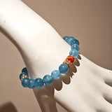 This is a gemstone bracelet that consists of 19pcs of 7-8mm aquamarine beads and 1pcs of red rutilated quartz. There are also 2 silver spacer beads in the bracelet. The main color of the bracelet is sky blue. The entire bracelet is translucent and beautiful.