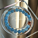 This is a gemstone bracelet that consists of 19pcs of 7-8mm aquamarine beads and 1pcs of red rutilated quartz. There are also 2 silver spacer beads in the bracelet. The main color of the bracelet is sky blue. The entire bracelet is translucent and beautiful.