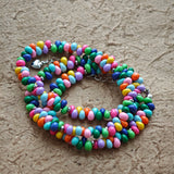 This is a bead necklace that consists of colorful peanut shape beads. It's as colorful as rainbow.