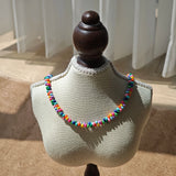This is a bead necklace that consists of colorful peanut shape beads. It's as colorful as rainbow.