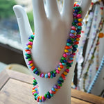 This is a bead necklace that consists of colorful peanut shape beads. It's as colorful as rainbow.