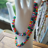 This is a bead necklace that consists of colorful peanut shape beads. It's as colorful as rainbow.