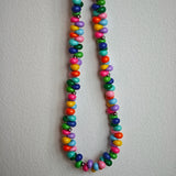 This is a bead necklace that consists of colorful peanut shape beads. It's as colorful as rainbow.