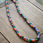 This is a bead necklace that consists of colorful peanut shape beads. It's as colorful as rainbow.