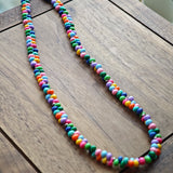 This is a bead necklace that consists of colorful peanut shape beads. It's as colorful as rainbow.