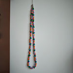 This is a bead necklace that consists of colorful peanut shape beads. It's as colorful as rainbow.