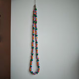 This is a bead necklace that consists of colorful peanut shape beads. It's as colorful as rainbow.