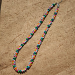 This is a bead necklace that consists of colorful peanut shape beads. It's as colorful as rainbow.