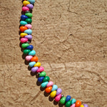 This is a bead necklace that consists of colorful peanut shape beads. It's as colorful as rainbow.
