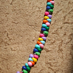 This is a bead necklace that consists of colorful peanut shape beads. It's as colorful as rainbow.