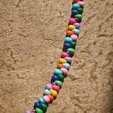 This is a bead necklace that consists of colorful peanut shape beads. It's as colorful as rainbow.