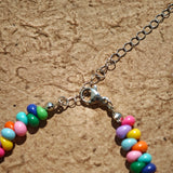 This is a bead necklace that consists of colorful peanut shape beads. It's as colorful as rainbow.
