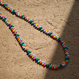 This is a bead necklace that consists of colorful peanut shape beads. It's as colorful as rainbow.