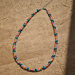 This is a bead necklace that consists of colorful peanut shape beads. It's as colorful as rainbow.