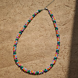 This is a bead necklace that consists of colorful peanut shape beads. It's as colorful as rainbow.