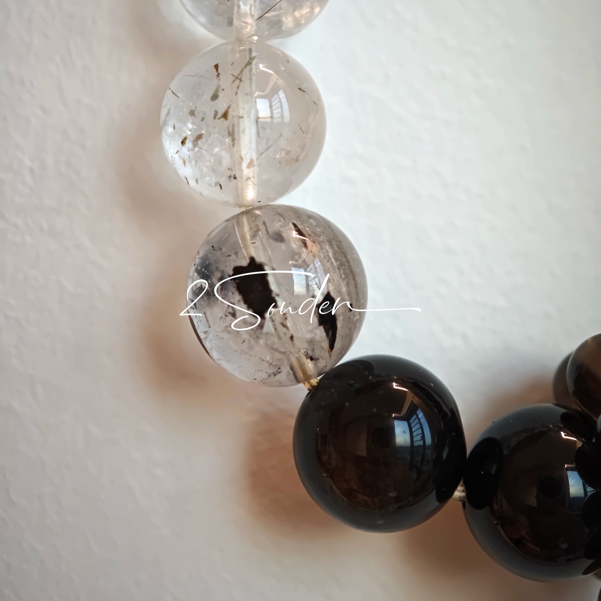 This is a crystal bracelet consists of Black Gold Ultra-Sparkle Azeztulite, Herkimer Diamond, Lace Black Rutilated Quartz, Obsidian and Tea Citrine Running Ring.