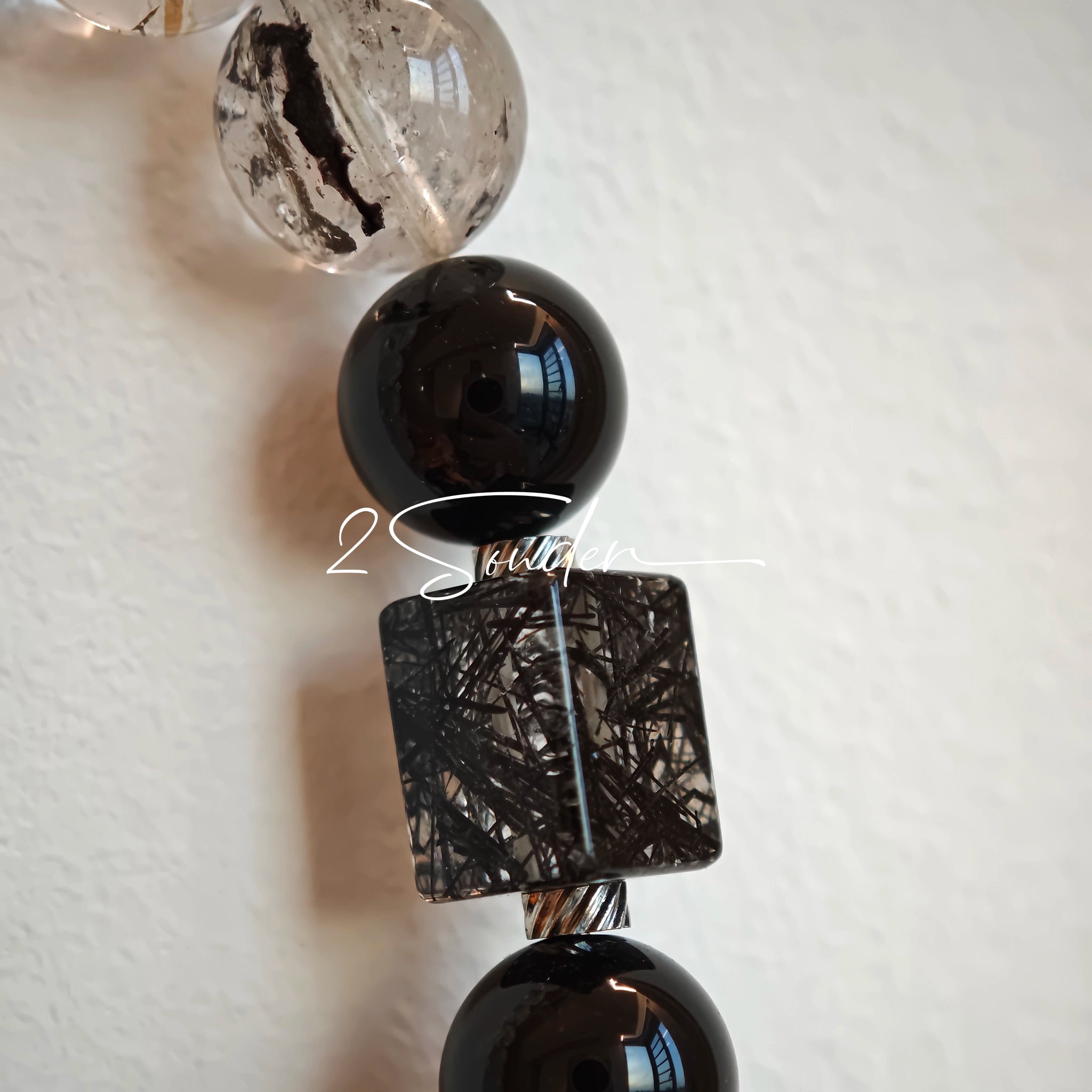 This is a crystal bracelet consists of Black Gold Ultra-Sparkle Azeztulite, Herkimer Diamond, Lace Black Rutilated Quartz, Obsidian and Tea Citrine Running Ring.