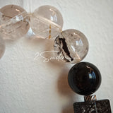 This is a crystal bracelet consists of Black Gold Ultra-Sparkle Azeztulite, Herkimer Diamond, Lace Black Rutilated Quartz, Obsidian and Tea Citrine Running Ring.
