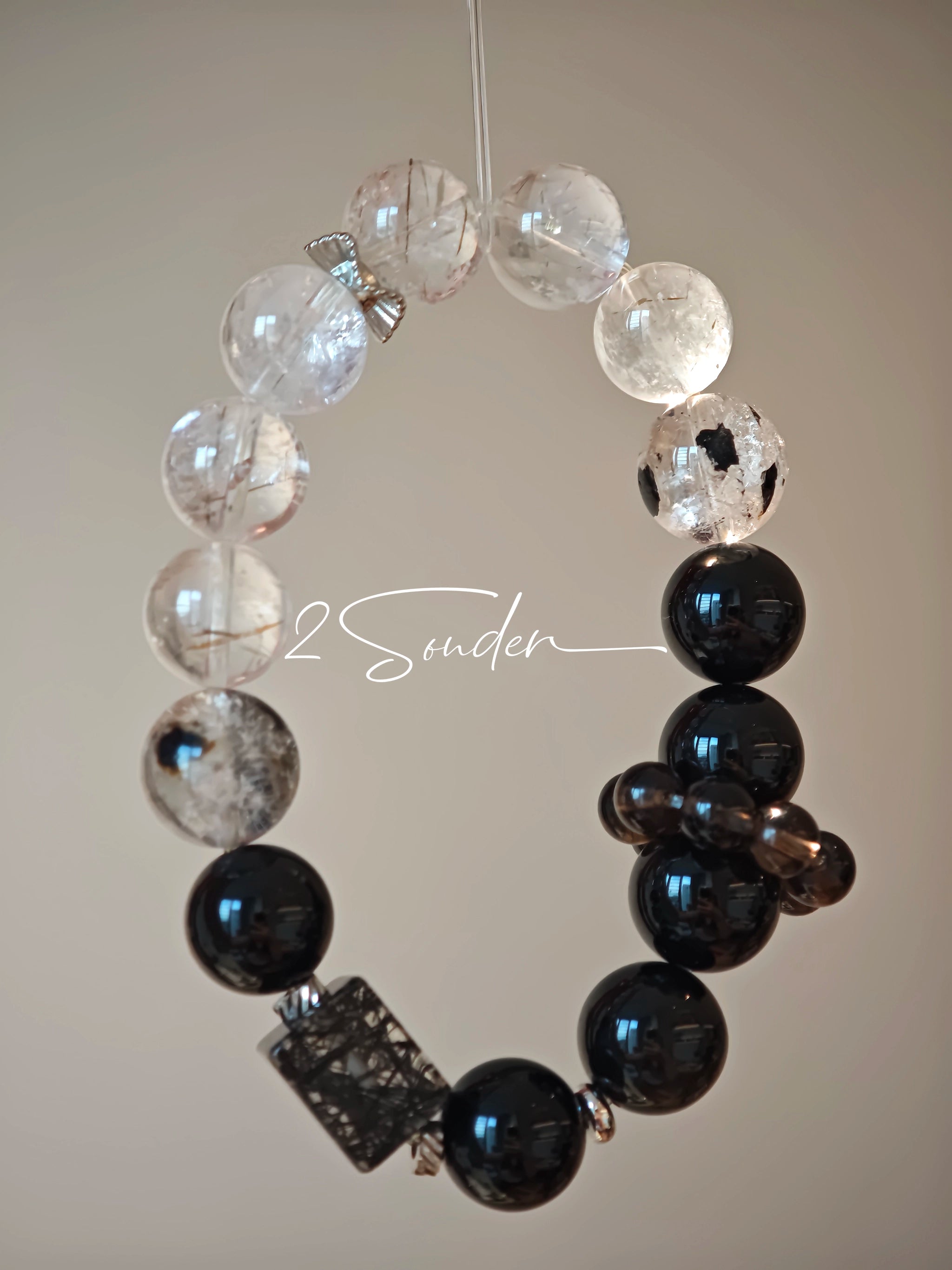 This is a crystal bracelet consists of Black Gold Ultra-Sparkle Azeztulite, Herkimer Diamond, Lace Black Rutilated Quartz, Obsidian and Tea Citrine Running Ring.