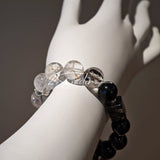 This is a crystal bracelet consists of Black Gold Ultra-Sparkle Azeztulite, Herkimer Diamond, Lace Black Rutilated Quartz, Obsidian and Tea Citrine Running Ring.