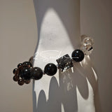This is a crystal bracelet consists of Black Gold Ultra-Sparkle Azeztulite, Herkimer Diamond, Lace Black Rutilated Quartz, Obsidian and Tea Citrine Running Ring.