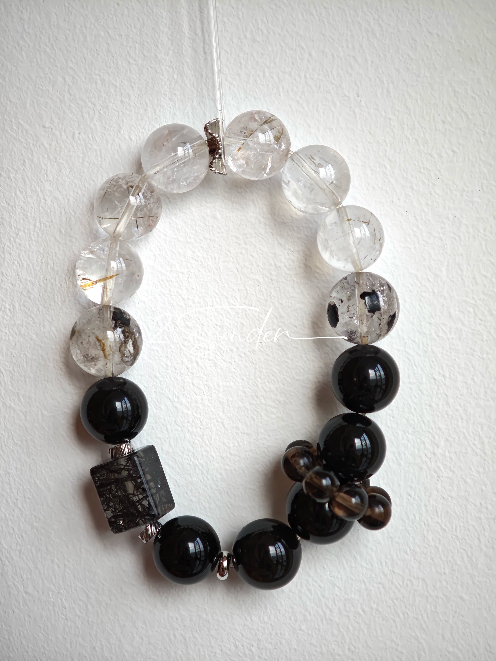 This is a crystal bracelet consists of Black Gold Ultra-Sparkle Azeztulite, Herkimer Diamond, Lace Black Rutilated Quartz, Obsidian and Tea Citrine Running Ring.