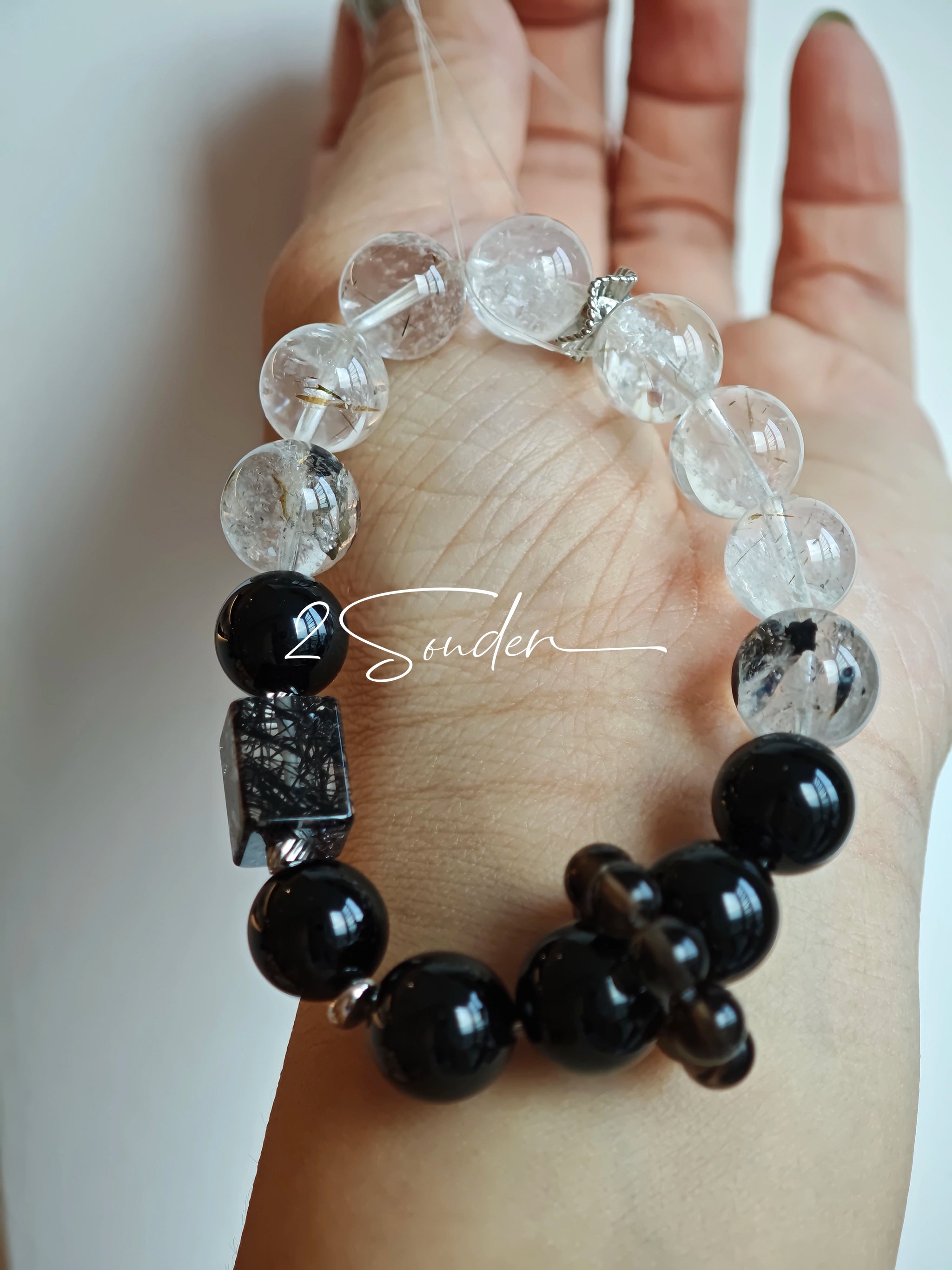 This is a crystal bracelet consists of Black Gold Ultra-Sparkle Azeztulite, Herkimer Diamond, Lace Black Rutilated Quartz, Obsidian and Tea Citrine Running Ring.