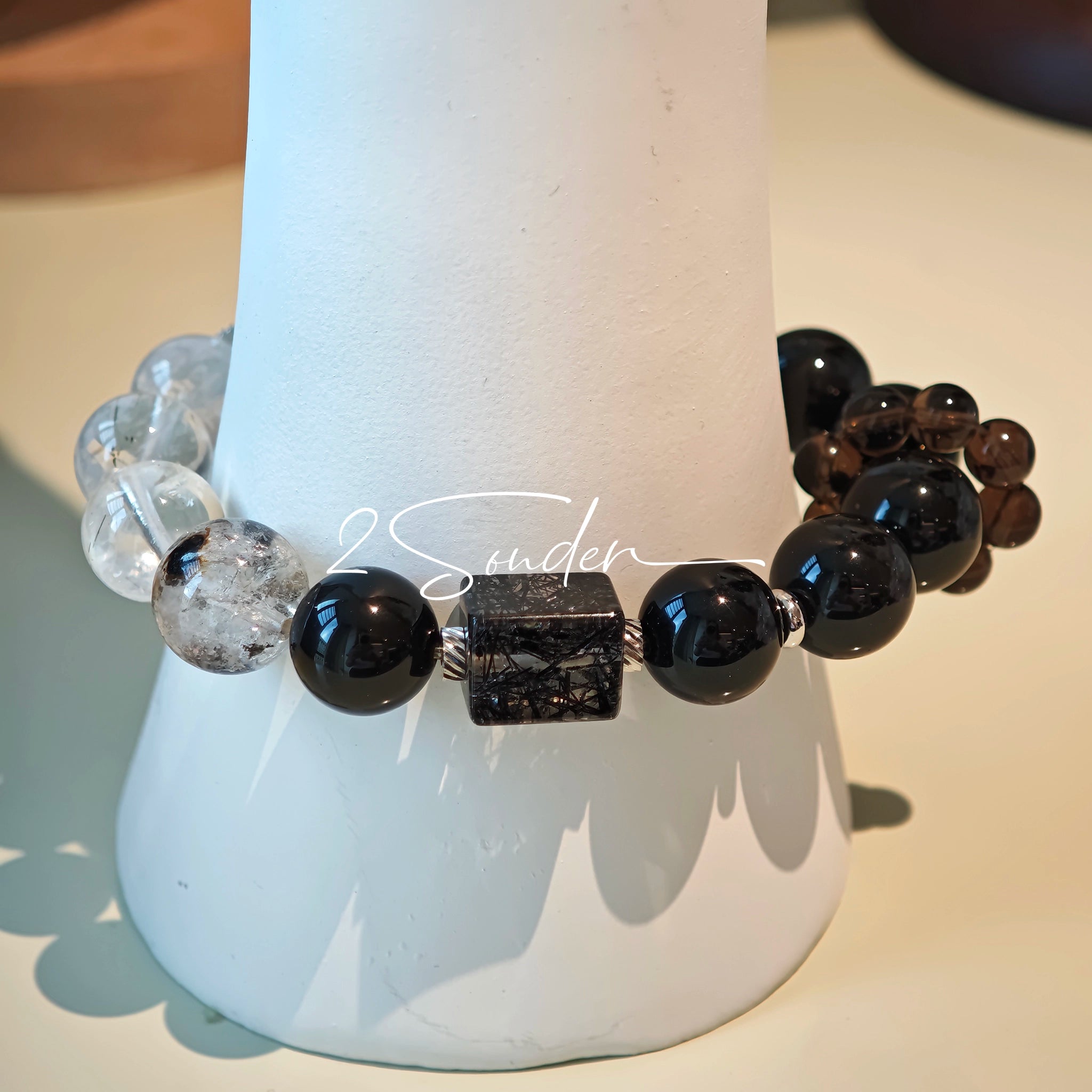 This is a crystal bracelet consists of Black Gold Ultra-Sparkle Azeztulite, Herkimer Diamond, Lace Black Rutilated Quartz, Obsidian and Tea Citrine Running Ring.