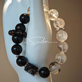 This is a crystal bracelet consists of Black Gold Ultra-Sparkle Azeztulite, Herkimer Diamond, Lace Black Rutilated Quartz, Obsidian and Tea Citrine Running Ring.