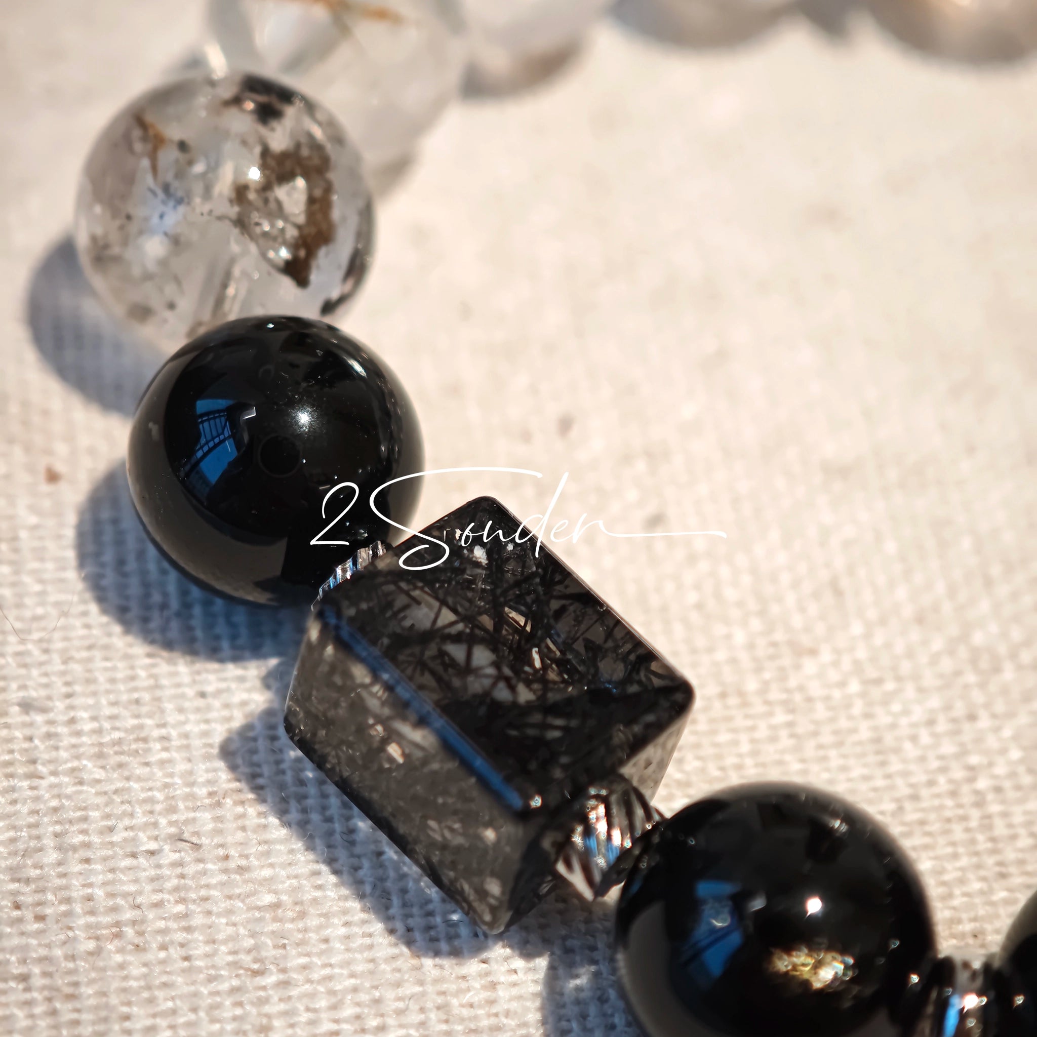 This is a crystal bracelet consists of Black Gold Ultra-Sparkle Azeztulite, Herkimer Diamond, Lace Black Rutilated Quartz, Obsidian and Tea Citrine Running Ring.