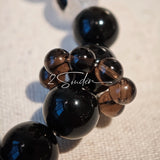 This is a crystal bracelet consists of Black Gold Ultra-Sparkle Azeztulite, Herkimer Diamond, Lace Black Rutilated Quartz, Obsidian and Tea Citrine Running Ring.