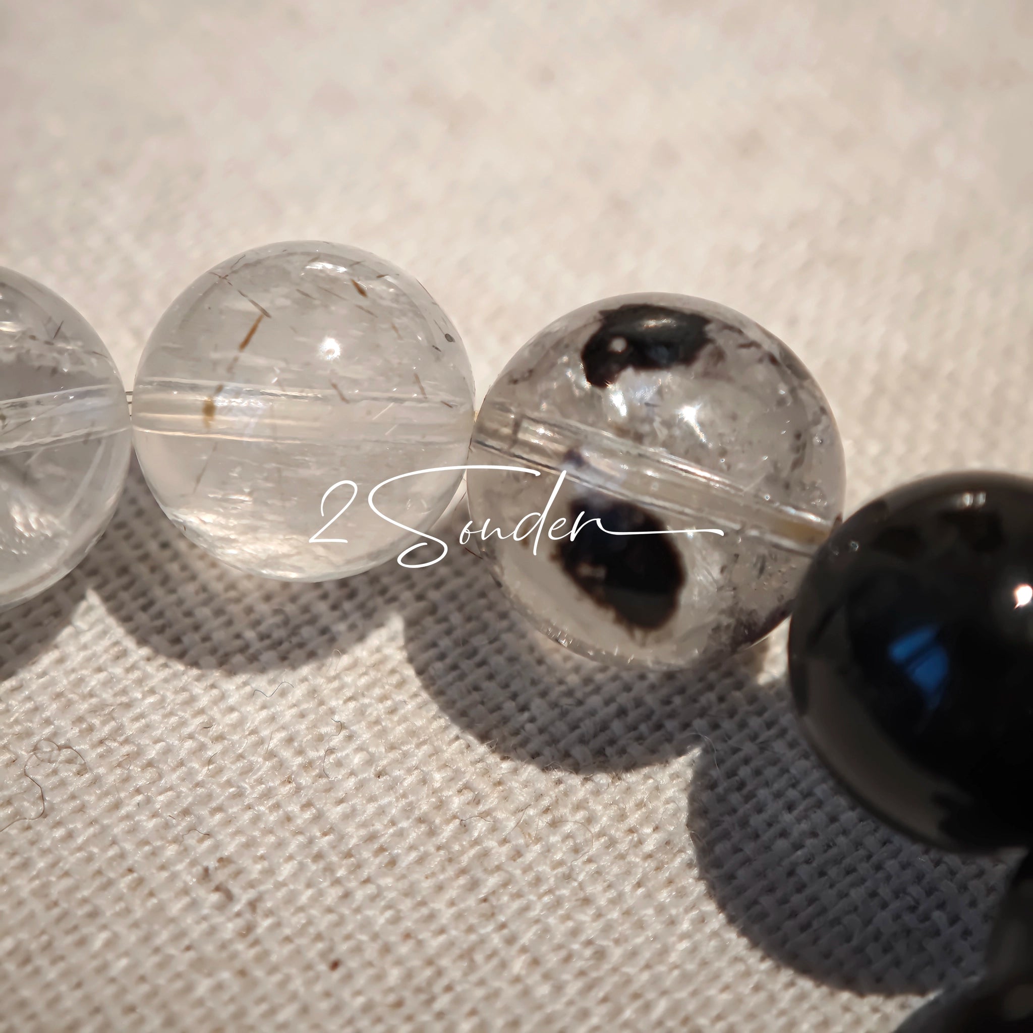 This is a crystal bracelet consists of Black Gold Ultra-Sparkle Azeztulite, Herkimer Diamond, Lace Black Rutilated Quartz, Obsidian and Tea Citrine Running Ring.