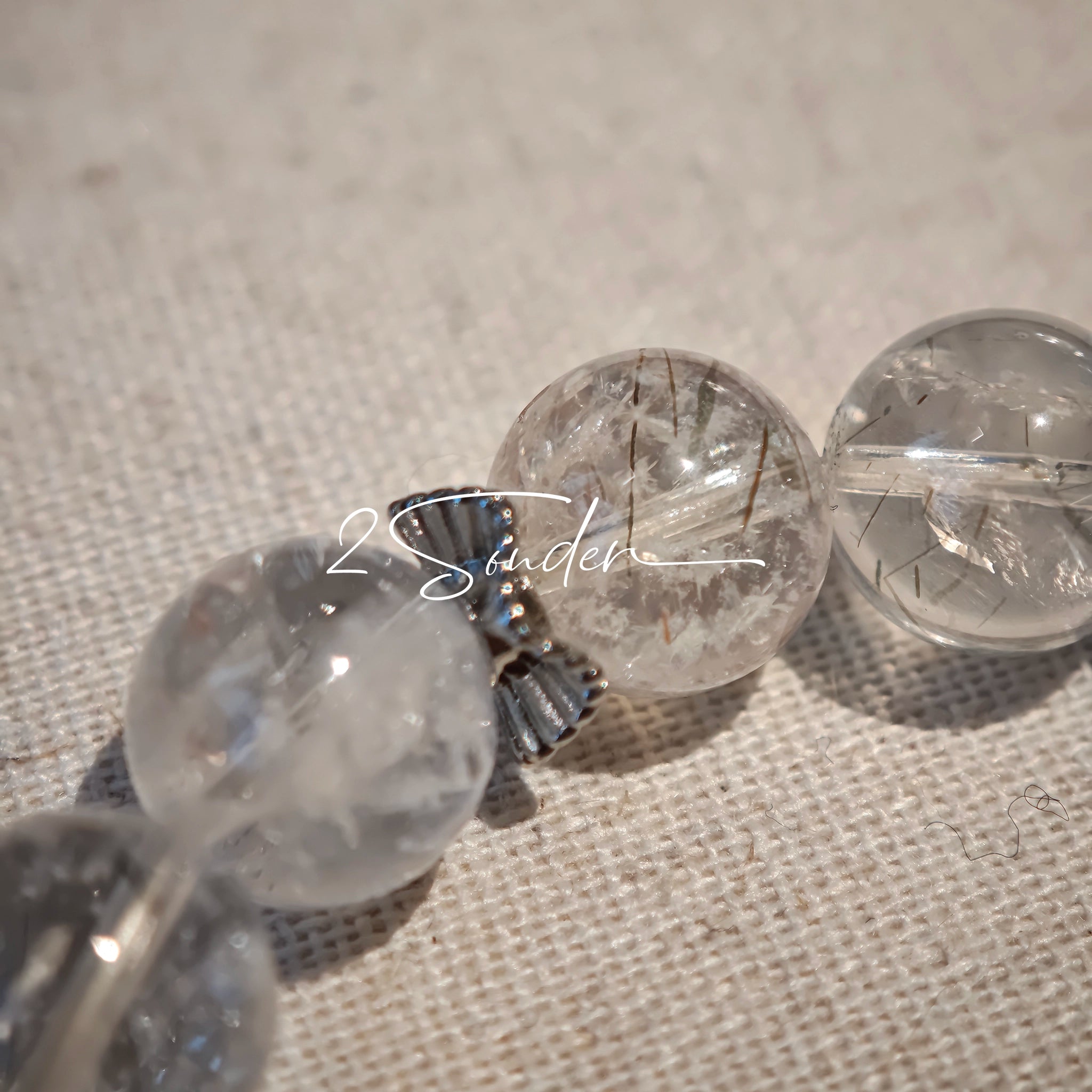 This is a crystal bracelet consists of Black Gold Ultra-Sparkle Azeztulite, Herkimer Diamond, Lace Black Rutilated Quartz, Obsidian and Tea Citrine Running Ring.