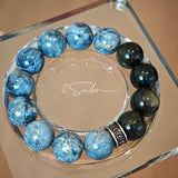 This is a bracelet consists of Blue Denim Pietersite and Golden Sheen Obsidian. The color of the bracelet is denim blue and black, accented by sleek silver spacer.