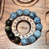 This is a bracelet consists of Blue Denim Pietersite and Golden Sheen Obsidian. The color of the bracelet is denim blue and black, accented by sleek silver spacer.