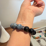This is a bracelet consists of Blue Denim Pietersite and Golden Sheen Obsidian. The color of the bracelet is denim blue and black, accented by sleek silver spacer.