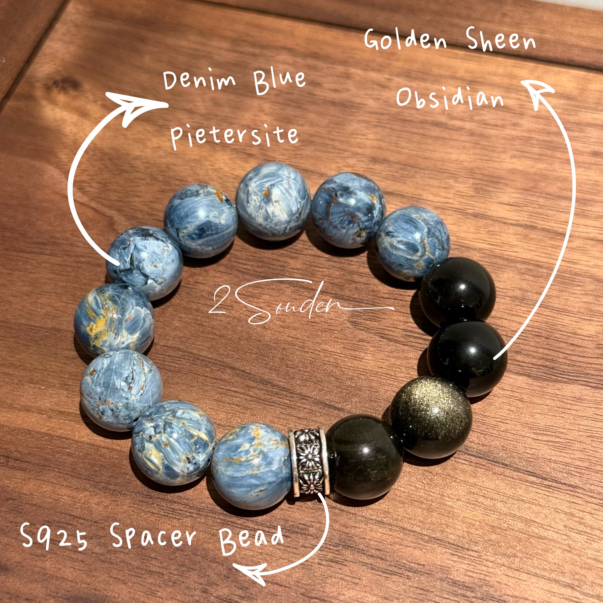 This is a bracelet consists of Blue Denim Pietersite and Golden Sheen Obsidian. The color of the bracelet is denim blue and black, accented by sleek silver spacer.