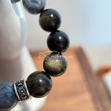 This is a bracelet consists of Blue Denim Pietersite and Golden Sheen Obsidian. The color of the bracelet is denim blue and black, accented by sleek silver spacer.